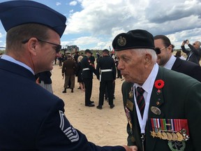 D-Day veteran James Parks, 96, is pictured during his last trip to Normandy in 2019. He is shaking hands with US service man Chief Master Sgt. Brent Bixby
