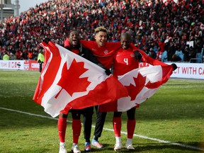Canadian players celebrate after qualifying for the World Cup 2022 in Qatar after beating Jamaica 4-0 in March.