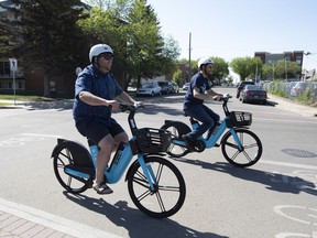 E-bikes and e-scooters are back for the year with Bird scooters being one of the suppliers.  Coun.  Michael Janz and Chadi Hachen, assistant general manager with Bird ride one of the e-bikes on Friday, June 3, 2022, in Edmonton.