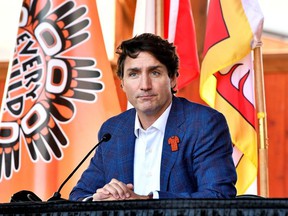 Prime Minister Justin Trudeau speaks to the press and Tk'emlups te Secweepemc community members and First Nations leaders at the Tk'emlups Pow wow Arbor in British Columbia, Oct. 18, 2021.