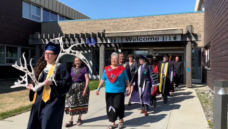 Amber Taylor-Fisher holds the Ceremonial Antler for the Yukon University's convocation procession followed by all the university's faculty and staff.