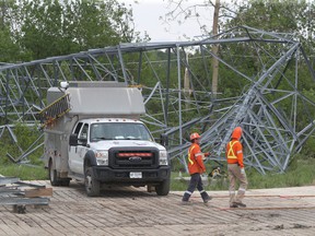 Hydro One works on some damaged and toppled towers near Hunt Club Road in Ottawa Tuesday.  Several towers were knocked down during last Saturday's storm.
