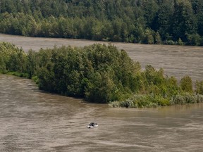 Sport fishermen are seen on a boat on the high and fast moving Fraser River, between Hope and Agassiz, BC, on Monday, July 6, 2020.