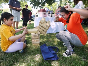 Summer Michener, left, 8, and her sister Storm Michener, 12, have a laugh playing jenga at the Windsor Indigenous Solidarity Day event at the Mic Mac Park on Tuesday, June 21, 2022.