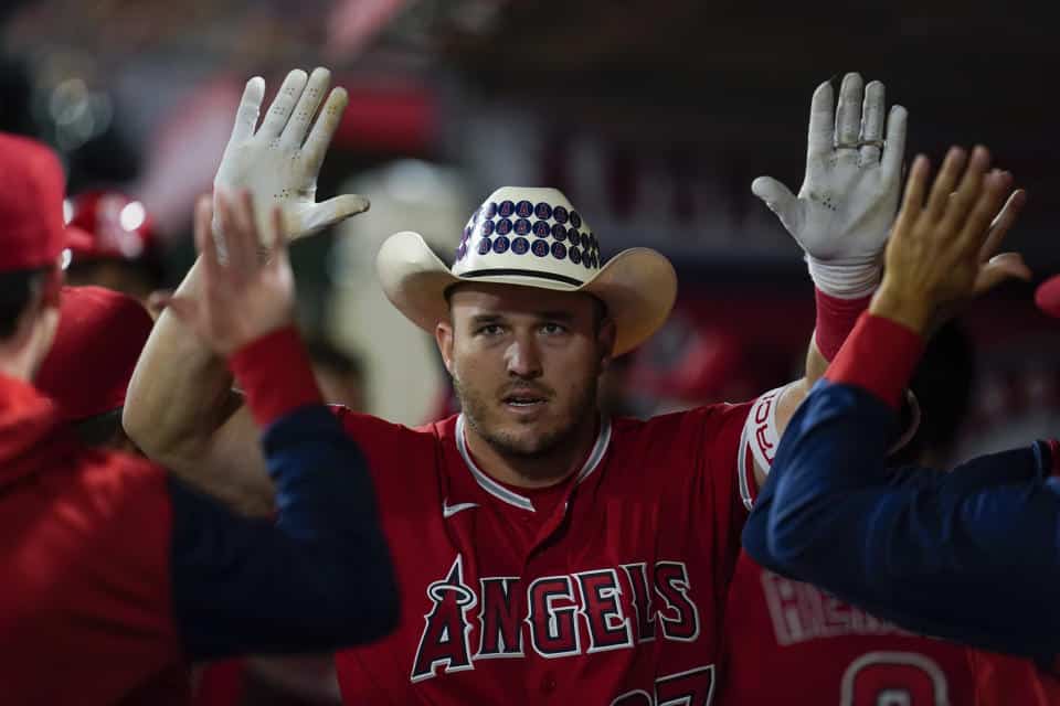 Los Angeles Angels' Mike Trout (27) celebrates in the dugout after hitting a home run during the seventh inning of a baseball game against the Toronto Blue Jays in Anaheim, Calif., on Saturday, May 28, 2022. ( AP Photo/Ashley Landis)