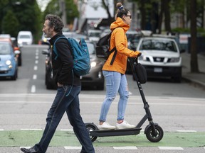 An e-scooter being used in downtown Vancouver.