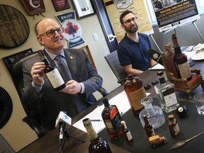 Windsor Mayor Drew Dilkens, left, and Craig Capacchione, Museum Windsor's exhibitions co-ordinator, shown during a media event on Monday, June 27, 2022, are asking residents to contribute artifacts like the ones in the mayor's collection to an upcoming prohibition-era exhibit.