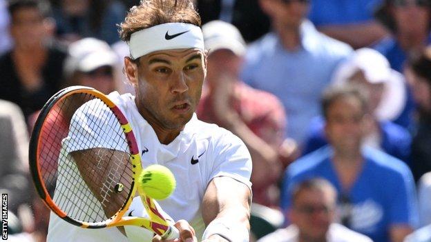 Rafael Nadal hits a return in his opening match of Wimbledon 2022