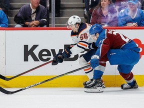 June 2, 2022;  Denver, Colo., USA;  Edmonton Oilers right wing Kailer Yamamoto (56) and Colorado Avalanche center Nathan MacKinnon (29) battle for the puck in the first period in game two of the Western Conference Final of the 2022 Stanley Cup Playoffs at Ball Arena.