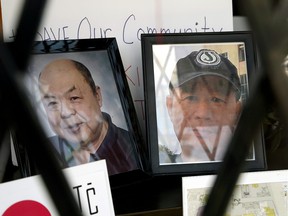 Photographs of Ban Phuc Hoang, 61, and Hung Trang, 64, two slain members of Edmonton's Chinatown community, are displayed in a shop window in Edmonton's Chinatown on June 1, 2022.