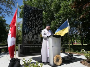 Father Tom Hrywna of Sts.  Vladimir and Olga Ukrainian Catholic Church speaks during a ceremony on Thursday, June 23, 2022 to rededicate the Holodomor Monument at the Jackson Park.