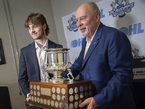 Ontario Hockey League commissioner, David Branch, right, presents Windsor Spitfires' center Wyatt Johnston with the Red Tilson Trophy after being named the league's most outstanding player.