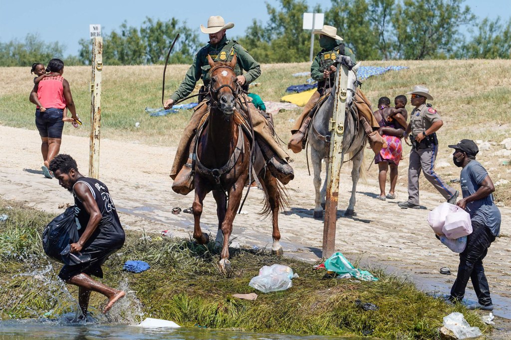 Border Patrol agents were photographed using the reins of their horses to whip Haitian immigrants on September 19. 