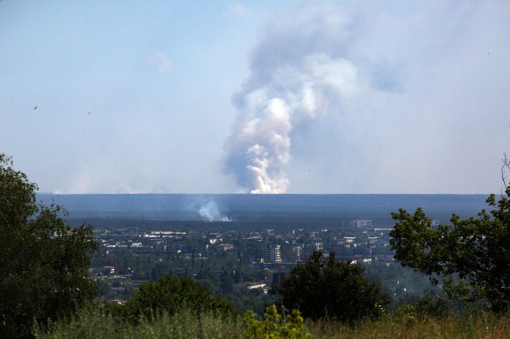 A large plume of smoke rises on the horizon behind the city of Severodonetsk amid Russia's invasion of Ukraine on June 21, 2022.