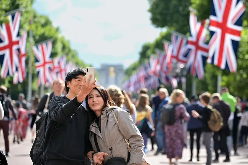 Members of the public walk along the Mall ahead of the upcoming Jubilee events on May 22 in London, England.