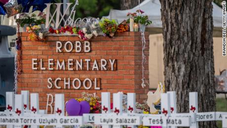     A monument is seen around the Robb Elementary School sign on May 26, 2022 in Uvalde, Texas. 