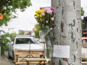 Flowers and a note are attached to a pole after a hit-and-run on June 19 left one person dead.