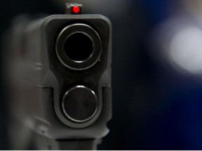 A view down the barrel of a semi-automatic handgun displayed at the143rd NRA Annual Meetings and Exhibits at the Indiana Convention Center in Indianapolis, Ind., on April 25, 2014.
