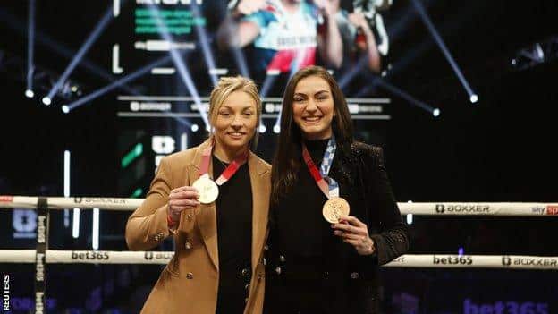 Lauren Price and Karriss Artingstall smile as they show off their Olympic medals