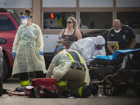 Fentanyl continues to take a heavy toll on local streets.  Here, EMS paramedics and Windsor firefighters work on a male patient suspected of having an overdose of fentanyl as he lies on the pavement outside Rally Auto Service on the corner of Marentette Avenue and Tecumseh Road East on May 28, 2020.